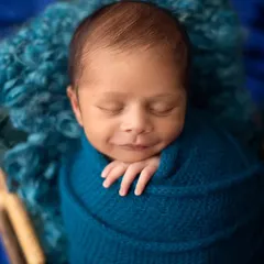 That little smirk is just priceless. It's amazing to see their little personalities shining through, even as they sleep.
