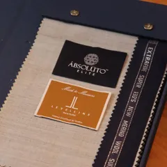 A glimpse into our premium fabric offerings, featuring Extrafine Super 130's Merino Wool from Absoluto Elite. This is the starting point for a truly luxurious suit.