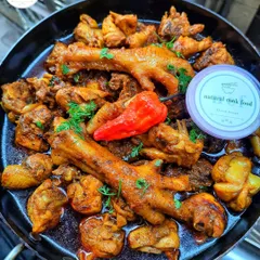 My country chicken stir fry, featuring chicken feet, which are a delicacy in our cuisine. It's cooked with spices until tender and flavourful.