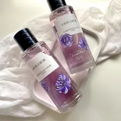 A finished look at the hand-painted 'Gris Dior' perfume bottles. I chose purple floral designs to match the color and name of the fragrance, adding layers of paint to create depth and definition on the glass surface.
