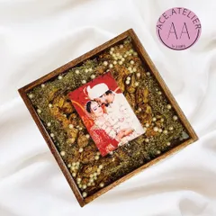 Your wedding photo and varmala, together forever. This square teakwood frame holds a couple's picture surrounded by their preserved wedding flowers and delicate pearls, capturing the essence of their day.