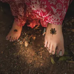 A very minimalist and modern take on foot mehendi. This design features a single, bold lotus flower on each foot, perfect for someone who wants a symbolic and chic tattoo-like design.