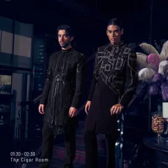 Two men, standing like a pause between chaos and calm. The sharp cuts and heavy shoulders of these jackets are softened by the sheen of dark velvet, an ode to quiet extravagance.