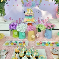 The dessert table for a unicorn-themed party, complete with a rainbow drip cake, unicorn-topped cupcakes, and pastel macarons. Every treat was designed to be part of the magical experience.