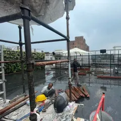 A work-in-progress shot from a large rooftop project. Our team works with professional equipment and scaffolding to ensure safety and precision during installation.