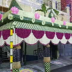This grand 'chapra' showcases my expertise in traditional decor. Intricately woven with coconut leaves and adorned with flowers, it creates an impressive and authentic welcome for guests at a home-based ceremony.