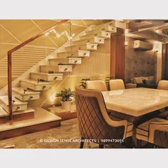 Another angle of the floating staircase design. The clean lines and mix of white marble and wood give it a light, airy feel, while the quilted dining chairs add a touch of sophisticated comfort to the space.