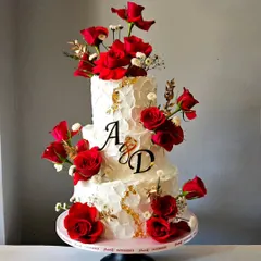 For an engagement that speaks of passion and elegance, I designed this three-tiered whipped cream cake. The contrast of the textured ivory frosting with the deep red of fresh roses and touches of gold leaf creates a timeless and romantic statement.