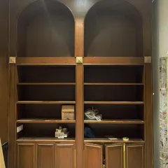 For the love of books. This grand, 12-foot-tall library unit was custom-designed with arched tops and ample shelving to house a client's extensive collection, creating a classic and scholarly focal point.