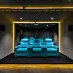 A dedicated home theater with plush recliner seats and ambient floor lighting. This design provides an immersive cinematic experience right at home.