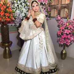 Two shots of a model in a white lehenga, showcasing a beautiful gold and kundan choker set. The jewellery provides a traditional contrast to the modern lehenga.
