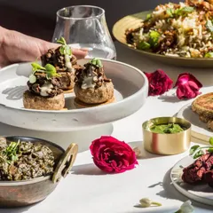 Our Modern Indian cuisine is about reimagining classics. Here, mushroom galouti is served on crisp discs, and saag is paired with hearty grains.