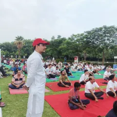 I have experience leading large scale wellness events for corporations and communities. Here, I am guiding a large group through a morning yoga session, creating a shared sense of peace and energy that participants carry with them throughout their day.