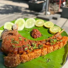 Our crispy pork ribs, seasoned with authentic Naga spices and served on a banana leaf. The skin is perfectly crackling while the meat remains tender and juicy. It’s a dish that’s both a feast for the eyes and a delight for anyone who loves rich, bold pork flavors.