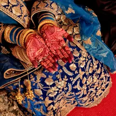 This is the beautiful, rich stain that develops from my 100% organic, chemical-free henna cones. The deep reddish-brown color, seen here against a bride's ornate blue lengha, is the result I always strive for.