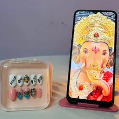 Creating these Ganpati-themed nails was a truly special experience. Each nail is hand-painted with details like a Ganesha portrait, lotus flowers, and auspicious symbols, making it a wearable piece of art for the festival.