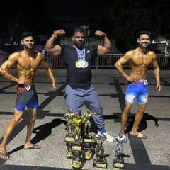 The result of teamwork and relentless effort. Posing with my two champions and their collection of trophies after the Mr. India competition. When my athletes win, I win.
