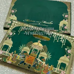 We bring royal celebrations to life with our hardback Pichwai-themed wedding invites. This design features a detailed illustration of a traditional wedding procession, complete with elephants and intricate architectural motifs. The rich emerald green and gold foil detailing make this a true keepsake for a grand Indian wedding.