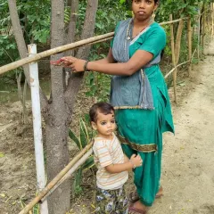 A woman from our community ties a rakhi to a sapling she helped plant. This beautiful gesture symbolizes her promise to protect and nurture this young tree as it grows.