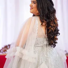 This client was getting ready to celebrate her anniversary in style. Her ethereal silver gown was paired with soft makeup and voluminous curls for a look that was pure elegance.
