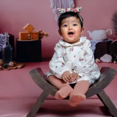 Our little fairy in her pretty garden. This studio setup has a lovely, rustic charm.