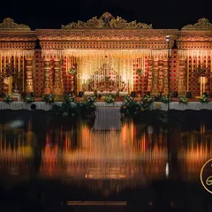 A breathtaking wide shot of the temple-style wedding stage, with its reflection creating a stunning visual.