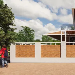 A close-up of a compound wall design that uses panels of exposed clay brick. This detail highlights our commitment to vernacular architecture, using local materials to create texture, warmth, and a connection to heritage.