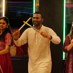 A student fully engaged in learning Dandiya Raas steps. Our choreography focuses on authentic moves that are easy for everyone to pick up.