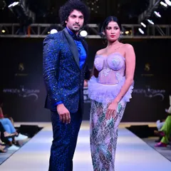 A custom-designed royal blue sequined tuxedo, perfect for making a statement. The jacket is fully embellished, paired with a satin lapel and a bright blue shirt for a coordinated, high-impact look.