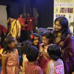 Our founder Madhumita surrounded by children after a performance. These moments of connection and interaction are the most rewarding part of our journey.