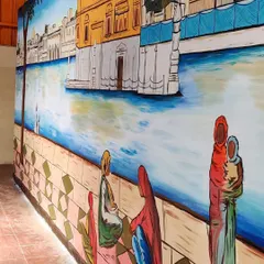 A side view of the Golden Temple mural, showing its scale and how it transforms the entire wall. The reflection in the water and the detailed architecture were key elements of this project.