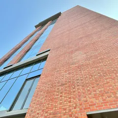 A low-angle shot of the completed brick and glass facade. This perspective emphasizes the verticality of the building and offers a clean, finished look at the material combination we envisioned from the start.