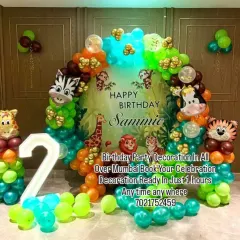 A vibrant jungle theme for Sammie's 2nd birthday. The decoration includes a lush jungle backdrop, animal head foil balloons on pillars, and a large light-up number '2'.