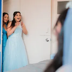 The priceless reaction of bridesmaids seeing the bride in her wedding dress for the first time. Capturing these genuine, emotional moments is a core part of my service.