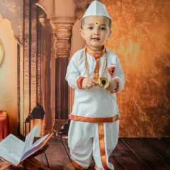 This little Varkari smiles while holding small cymbals, a key element of the devotional theme. This standing pose is great for capturing one-year-olds who are just finding their feet.