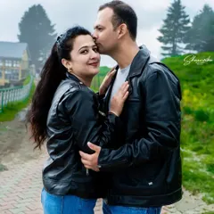 A sweet and intimate moment during a pre-wedding shoot. The misty mountain background adds a touch of romance to this beautiful couple portrait.