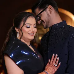 A dreamy sangeet look captured in a candid moment. The makeup features radiant skin and bold, sparkling eyes that perfectly complement the couple's joyous celebration.