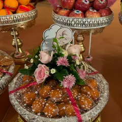 A platter of sweets decorated for a baby shower. I used fresh pink roses and a cute baby chef cutout to create a unique and charming look for the occasion.