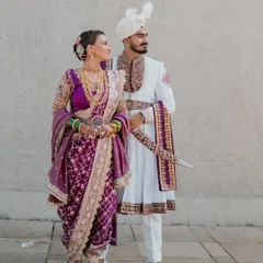 A regal pose showing the elegance of the Peshwai bride and groom. The bride's Nauvari is rich in detail, and her makeup is kept classic to complement the grandeur.