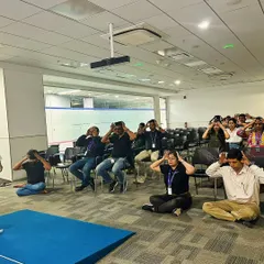 A duplicate image of the group practicing Bhramari Pranayama (Bee Breath) during a corporate meditation session.