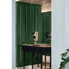 A detail shot of the console table in the grand green foyer. The deep green lacquered panels and custom art pieces create a sophisticated and welcoming vignette.