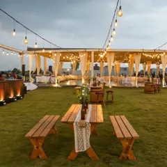 Lighting is poetry. For Sonam and Ross's Mehendi, we used strings of Edison bulbs, rustic conversation tables, and unique bottle art to evoke a warm and inviting mood for their guests to relax and celebrate.
