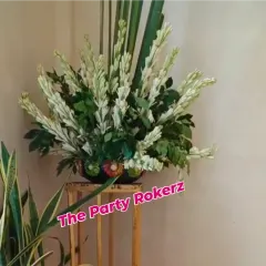 A simple and elegant floral arrangement of white tuberoses (rajnigandha) used as part of the decor for a Teej celebration.