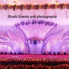 This grand reception stage features a unique lotus-petal design made entirely of pink and white flowers. The intricate floral work and dramatic lighting create a stunning visual centerpiece for the event.