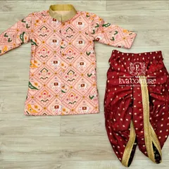 A stylish boys' kurta set featuring a pink printed kurta with elephant motifs. It is paired with a rich maroon dhoti that has a simple gold border.