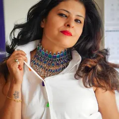 Another view of the statement choker, showing how it can transform a classic sleeveless white shirt into a unique and eye-catching ensemble.