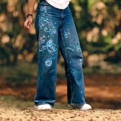 I gave my old, favorite pair of jeans a cosmic makeover. I painted them with swirling blue and white patterns that evoke a sense of space and movement, turning them into something truly unique.