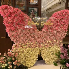 We crafted this breathtaking butterfly backdrop from hundreds of fresh pink and cream roses for a truly magical cradle ceremony. This statement piece creates a stunning focal point and a perfect photo opportunity, celebrating new life in the most beautiful way.