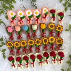 A whole garden of my mini crochet bouquet keychains. These adorable handmade accessories come in a variety of flowers like daisies, tulips, sunflowers, and roses.