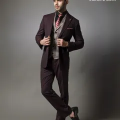Another angle of the burgundy three-piece suit, showing how the garment moves with the wearer. The clean lines are maintained even in a dynamic pose.